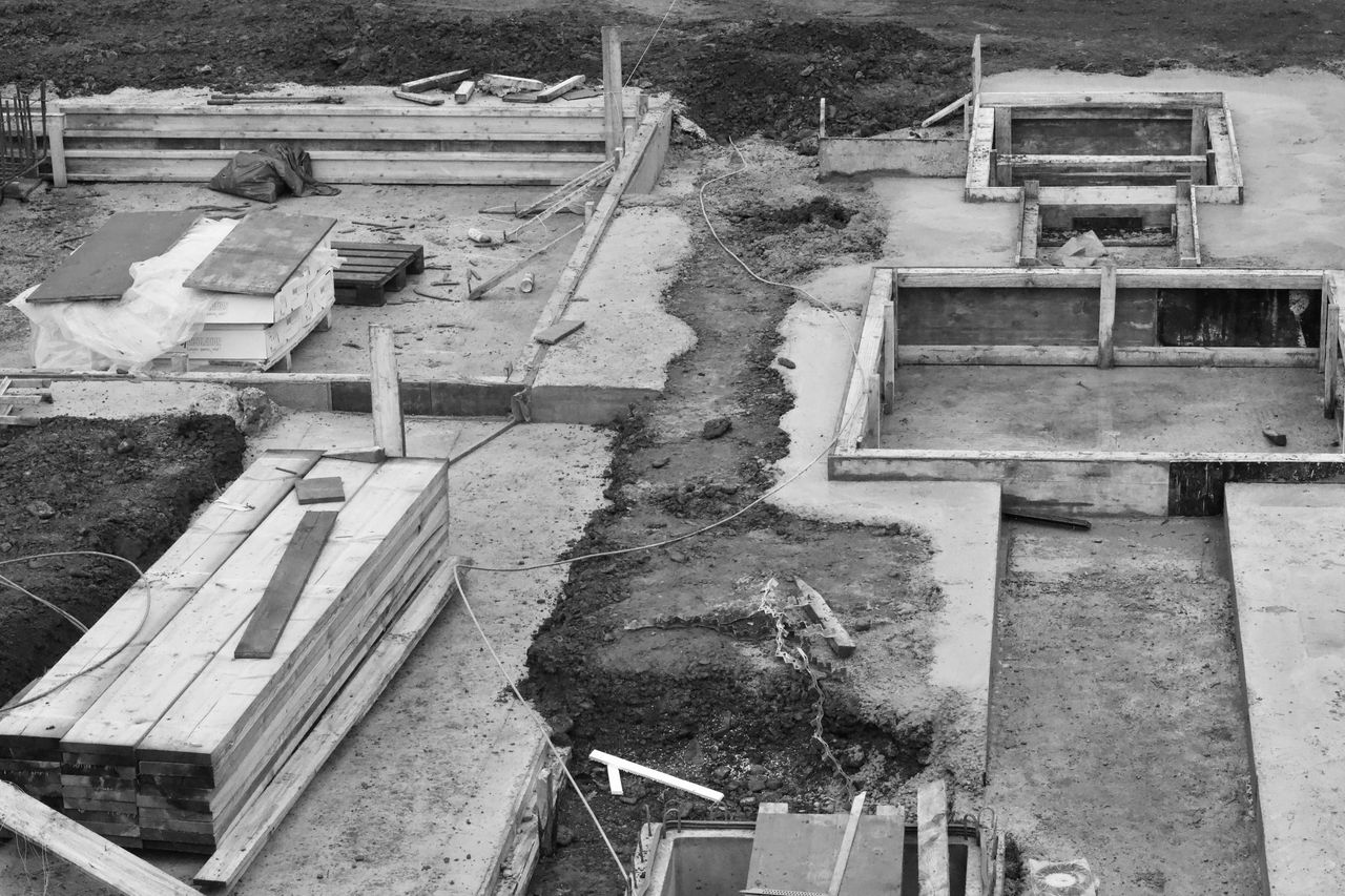 Aerial view of concrete foundations at a construction site, showing early building phases.